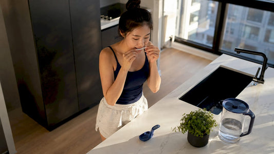 Woman applying teeth whitening strips at home