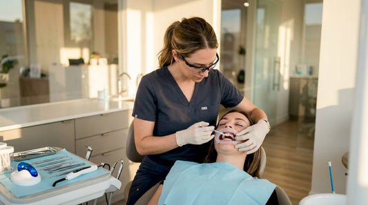 Dental professional applying whitening gel in clinic