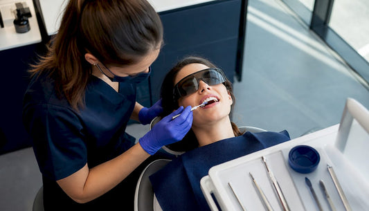Dental professional applying whitening gel in clinic