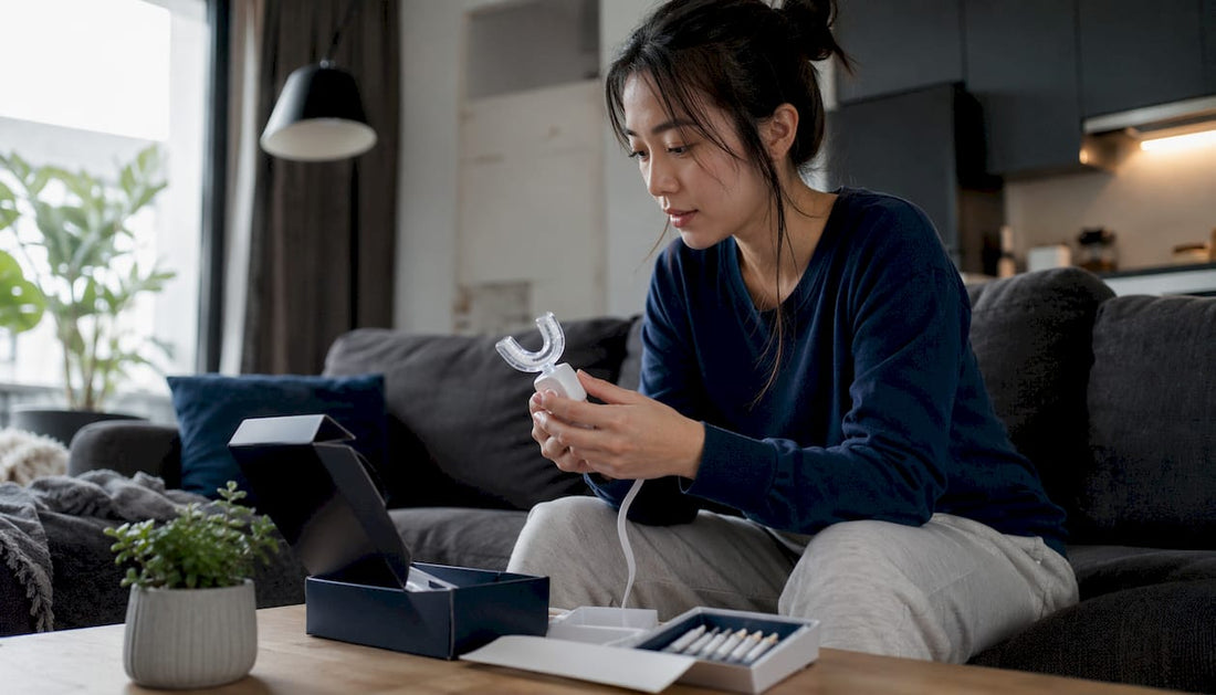 Woman using at-home teeth whitening kit