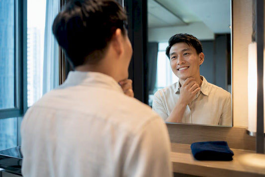 Adult checking smile in mirror at home