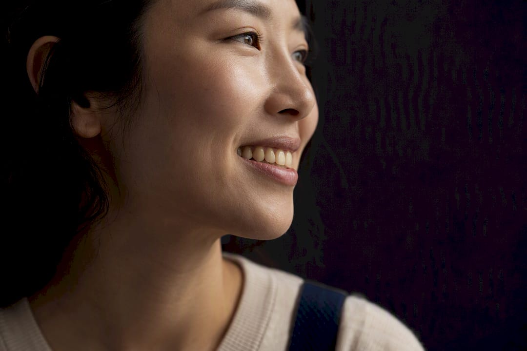 Adult showing naturally warm-toned healthy smile