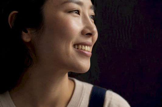 Adult showing naturally warm-toned healthy smile